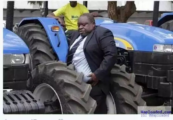 LOLZ!! See Funny Pictures Of A Pot-Bellied Man Stuck In Between Tractors [Photo]